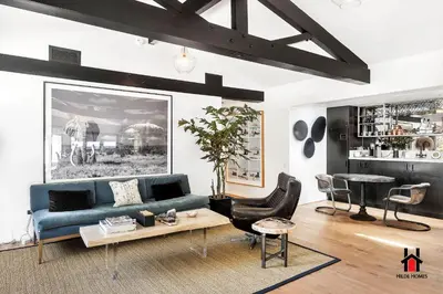a living room with a blue couch and a table at Resort Feel I Breathtaking Mountain Scenery I Pool in Malibu