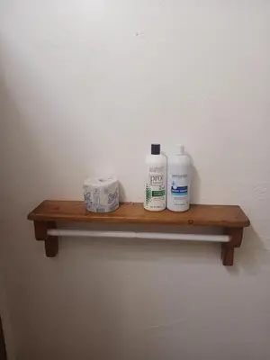 a wooden shelf with toiletries on a wall at Boulder Bay Cottages in Big Bear Lake