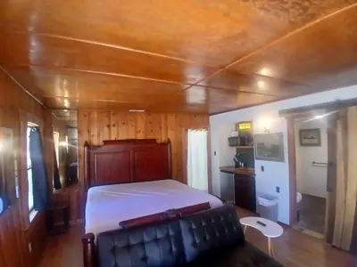 a bedroom with a bed and a couch in a room at Boulder Bay Cottages in Big Bear Lake