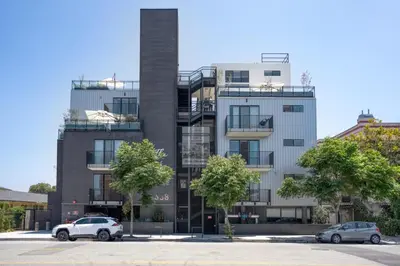 a building with two cars parked in front of it at Culver City 1br w rooftop lounge access to 405 LAX-1124 in Los Angeles