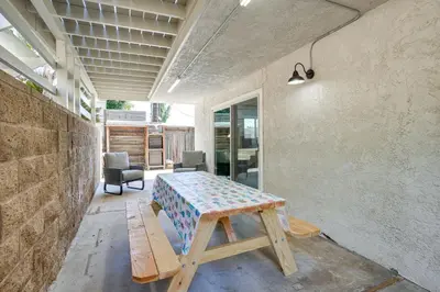 a room with a wooden table and a bench at Chic Santa Paula Home with Mountain and City Views! in Santa Paula