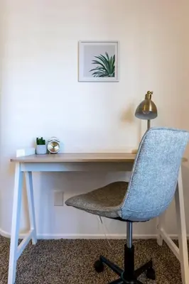 a desk with a chair and a desk with a lamp at The Nest at Woodside: Lux LA getaway + office/spa in Santa Clarita