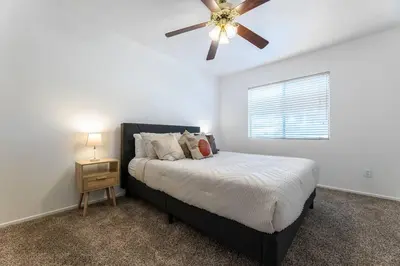 a bedroom with a bed and a ceiling fan at The Nest at Woodside: Lux LA getaway + office/spa in Santa Clarita