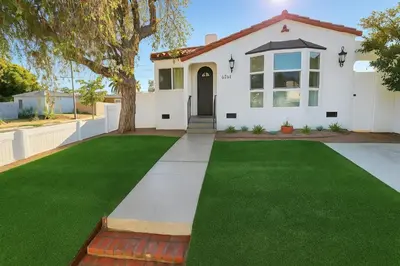 a white house with a green lawn at Bright Corner Home Retreat Near SoFi in Los Angeles