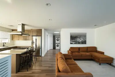 a kitchen and living room with a couch and a table at Bright Corner Home Retreat Near SoFi in Los Angeles
