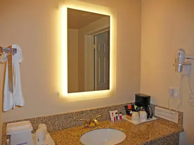 a bathroom with a sink and a mirror at Howard Johnson by Wyndham Pasadena in Pasadena