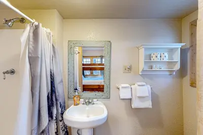a bathroom with a sink and a mirror at Heliotrope Hideaway in Lake Arrowhead