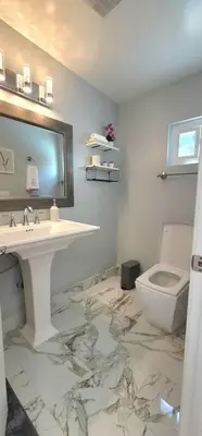 a bathroom with a sink and a toilet at Newly Furnished Pool House in Los Angeles