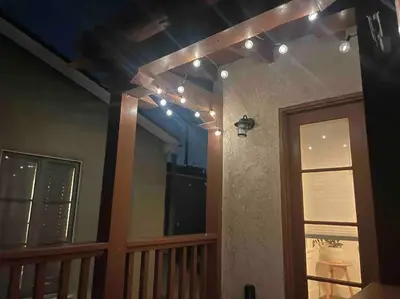 a room with a balcony with lights on the ceiling at Huge Updated Spanish Apt - Steps to Beach & Bay! in Long Beach