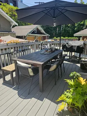 a wooden table and chairs with an umbrella on a deck at Tranquility at the House of Alchemy Hollywood in Los Angeles