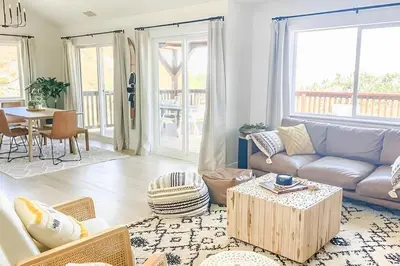 a living room with a couch and a table at NEW & Luxurious House, hot tub & amazing views in Lake Arrowhead