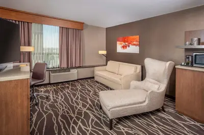a hotel room with a chair and a television at DoubleTree by Hilton San Bernardino in San Bernardino