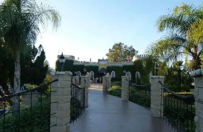 a gate to a castle with a fence and palm trees at Stylish Sherman Oaks Townhouse 3bed + 3.5bath All Master Suites in Los Angeles