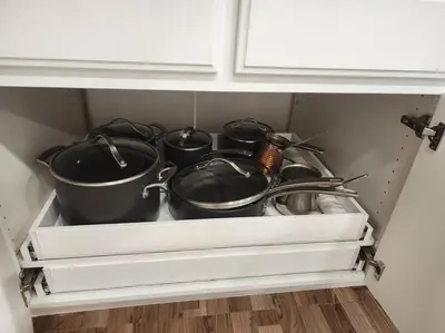 a drawer full of pots and pans in a cabinet at Pine Mountain Club Family Vacation House in Pine Mountain Club