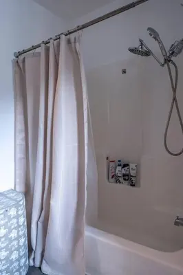 a bathroom with a shower curtain next to a bath tub at Pine Mountain Club Family Vacation House in Pine Mountain Club