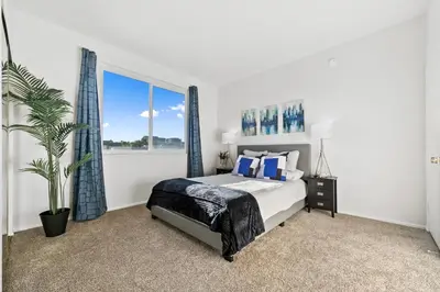 a bedroom with a bed and a large window at Beverly Hills Penthouse 2 BR Apt with Parking 407 in Los Angeles