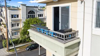 a balcony with a blue railing on a building at Beverly Hills Penthouse 2 BR Apt with Parking 407 in Los Angeles