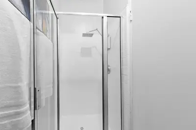 a shower with a glass door in a bathroom at Beverly Hills Penthouse 2 BR Apt with Parking 407 in Los Angeles