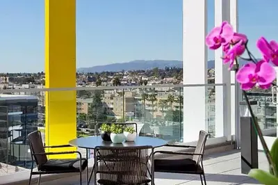 a table and chairs on a balcony with pink flowers at Culver City 1br w pool gym easy access to 405 LAX-1136 in Los Angeles