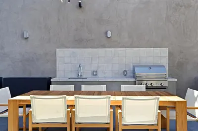 a kitchen with a wooden table and white chairs at Culver City 1br w pool gym easy access to 405 LAX-1136 in Los Angeles