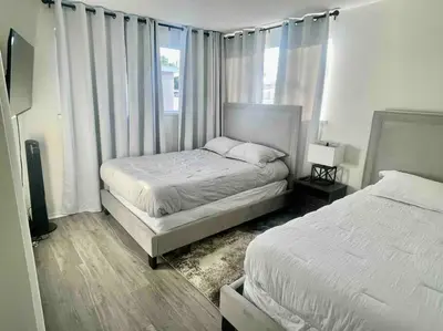 a bedroom with two beds and a window at Glendora Pool Home Retreat in Glendora