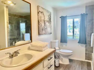 a bathroom with a sink and a toilet and a mirror at Glendora Pool Home Retreat in Glendora