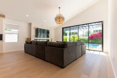 a living room with a couch and a large window at Universal Studio Stellar Home with pool and jacuzzi in Los Angeles