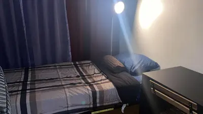 a small bedroom with a bed in a room at Zen Home in Santa Ana