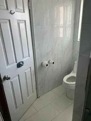 a white bathroom with a shower and a toilet at Zen Home in Santa Ana