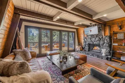 a living room with a couch and a fireplace at Stunning Cabin with Private Deck in Big Bear City