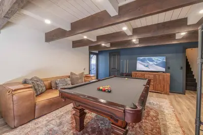 a living room with a couch and a pool table at Stunning Cabin with Private Deck in Big Bear City