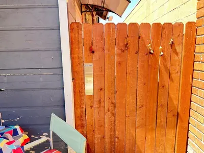 a wooden fence in front of a house at Little Betty's Casita in Torrance