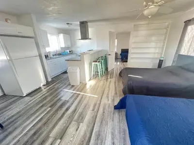 a large room with a kitchen and a bed at Little Betty’s Hideaway in Torrance