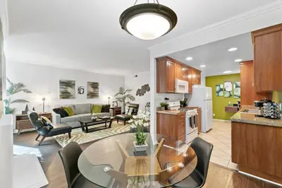 a kitchen and living room with a table and chairs at Beverly Hills Gem 1 BR Apt with Parking 218 in Los Angeles
