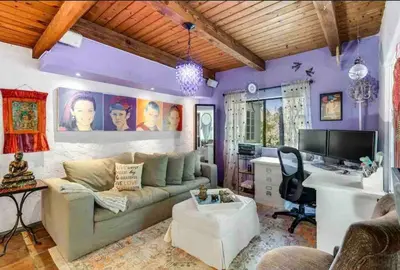 a living room with a couch and a desk at Boho Chic Malibu Retreat Estate Salt Pool + Yoga in Malibu
