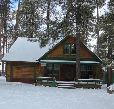 a log cabin with snow on the ground in front at Mountain Getaway in Big Bear Lake