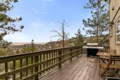 a deck with a stove and a grill on a house at Panoramic Views at Deer Crest Lodge in Lake Arrowhead