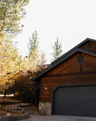 a barn with a garage door in front of it at Namu Cabin in Big Bear Lake