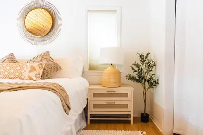 a bedroom with a bed and a lamp on a night stand at Namu Cabin in Big Bear Lake