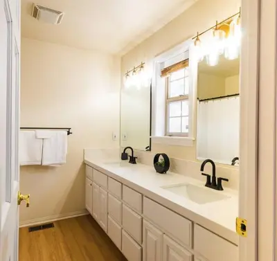 a bathroom with a sink and a mirror at Namu Cabin in Big Bear Lake