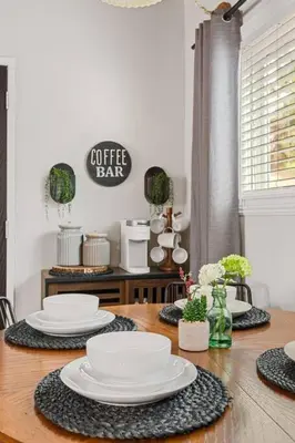 a dining room table with white plates on it at Brunos Bungalow in Big Bear Lake
