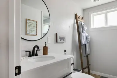 a bathroom with a sink and a mirror at Brunos Bungalow in Big Bear Lake