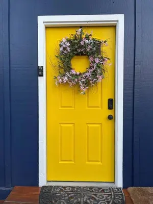 a yellow door with a wreath on it at Brunos Bungalow in Big Bear Lake