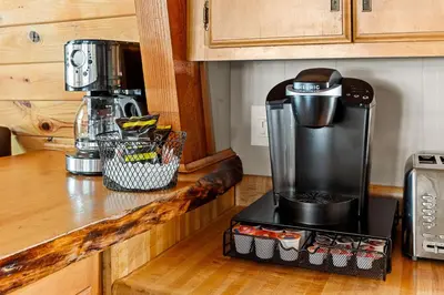 a coffee maker on a counter in a kitchen at The 99 Pines Walk to Snow Summit Hot Tub in Big Bear Lake