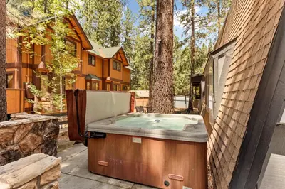 a hot tub sitting on the side of a house at The 99 Pines Walk to Snow Summit Hot Tub in Big Bear Lake