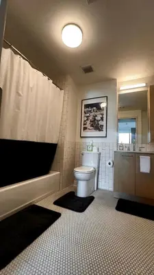 a bathroom with a toilet and a tub and a sink at Center of Hollywood in Los Angeles