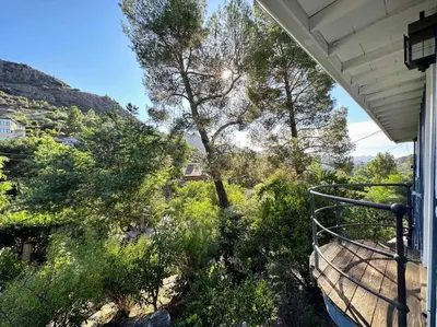 a balcony of a house with trees and bushes at Malibou Lake Oasis in Agoura Hills