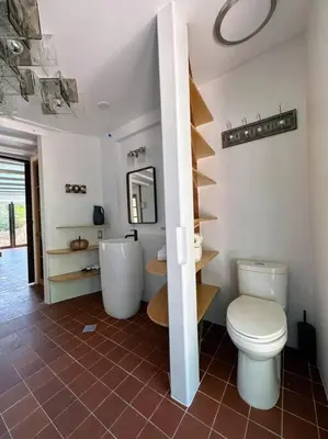 a bathroom with a toilet and a sink at Malibou Lake Oasis in Agoura Hills