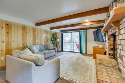 a living room with a couch and a fireplace at The Abby Cabin Restful Running Springs Retreat! in Running Springs