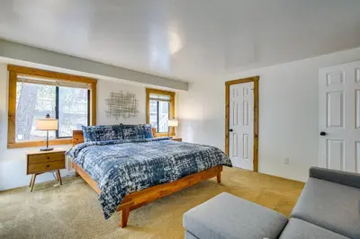 a bedroom with a bed and a couch at The Abby Cabin Restful Running Springs Retreat! in Running Springs